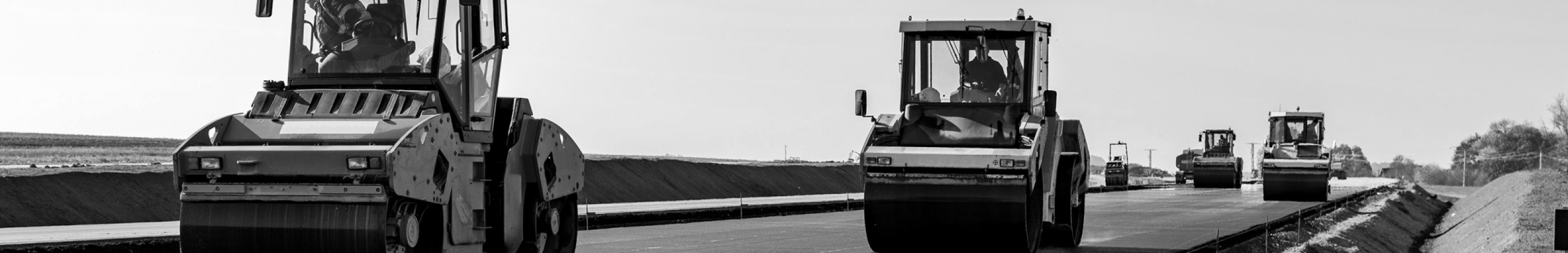 Sears Paving seating products. Picture of paving compactors working on new road.